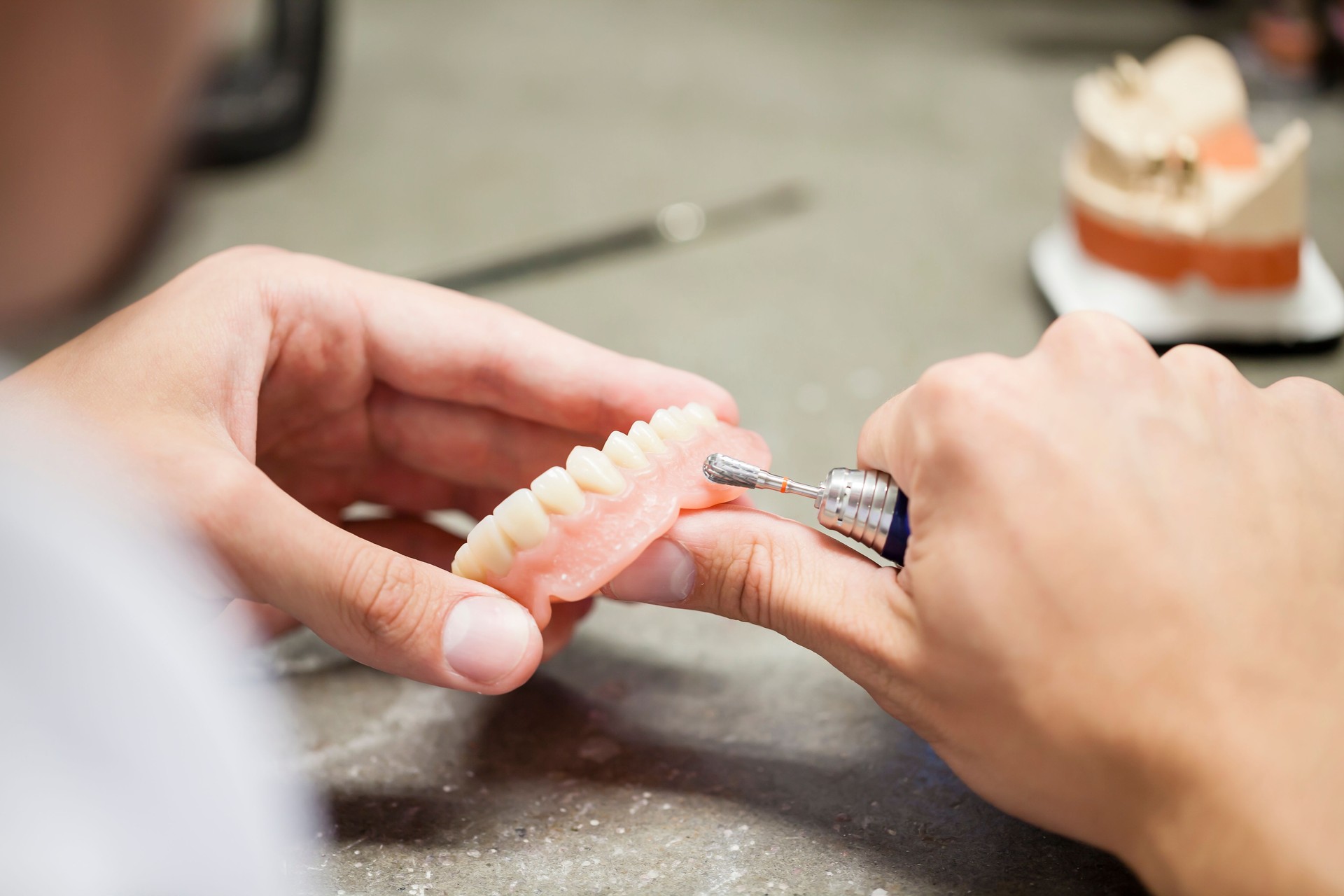 Dental technician working on a dention